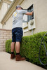 Iron & Haft Men's Journeyman Work Jean Shorts, man working on an electrical panel outside wearing casual outfit and rugged brown work shorts.