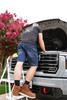 Iron & Haft Men's Journeyman Work Jean Shorts IHJSH, a pair of denim work shorts worn by a man standing on a small ladder while repairing a vehicle