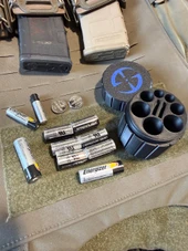 LAPG Tactical Spare Battery Container TDP-RDBATTHOLDER 840277252944, round black container with blue logo, with multiple batteries and batteries holders around it. Thumbnail Image
