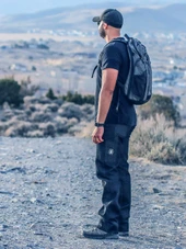 Kitanica American Jeans 301-KN, rugged men's jeans worn by a man outdoors in a rugged terrain setting. Thumbnail Image