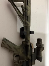 LAPG AR-15 Buffer Tube Wall Mount, tactical scope, and firearm accessories mounted on a wall. Thumbnail Image