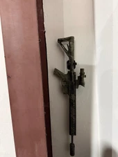 LAPG AR-15 Buffer Tube Wall Mount TDP-ARWM, tactical rifle wall mount for AR-15 buffer tubes, mounted on a wall. Thumbnail Image