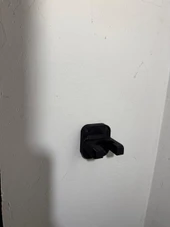 LAPG AR-15 Buffer Tube Wall Mount TDP-ARWM, black metal wall mount for rifle buffer tubes attached to a white textured wall. Thumbnail Image