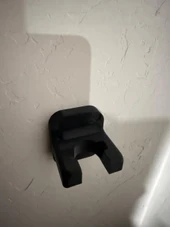 LAPG AR-15 Buffer Tube Wall Mount TDP-ARWM, product image showing black wall mount for AR-15 buffer tubes attached to a wall. Thumbnail Image