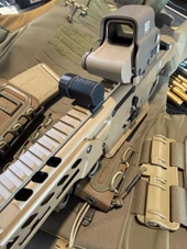 LAPG Picatinny Rail Battery Storage Container - 2 Pack, tactical firearm accessories mounted on a tan rifle with tactical gear in the background. Thumbnail Image