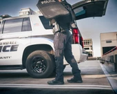 OTB Boots Fusion 6 Black Tactical Boot, police officer standing next to police vehicle with open trunk. Thumbnail Image