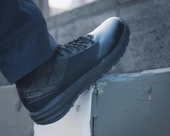 OTB Boots Fusion 8 Black Tactical Boot, a close-up of a black tactical boot worn by a person, showcasing its durable design and rugged sole. Thumbnail Image