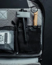 Eberlestock Fade Tactical Admin Pouch FA4MB, inside view showing organization compartments with various tactical tools and accessories.