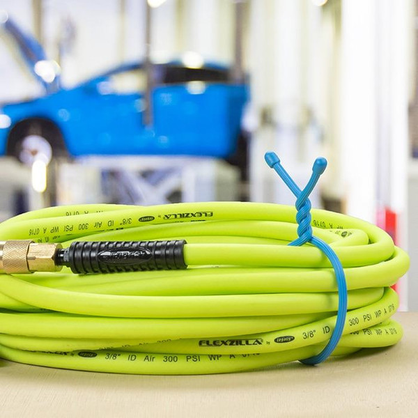 Nite Ize Gear Tie Reusable Rubber Twist Tie 18 in. - 2 Pack, coiled bright yellow flexible rubber ties with a blue twist tie secured around the coils for easy organization and bundling.