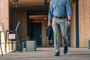 5.11 Tactical 1.5 Casual Leather Belt modeled n man walking in blue shirt and grey pants