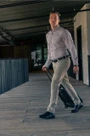 5.11 Tactical 1.5 Casual Leather Belt  modeled on man walking in grey pants and shirt