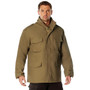 Rothco M-65 Field Jacket, military-style tan combat jacket with multiple front pockets, epaulets on shoulders, and stand-up collar, worn by a male model.