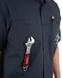 Iron & Haft Tradesman Short Sleeve Stretch Canvas Work Shirt, close-up view showing chest pockets with buttons and a wrench in the pocket.