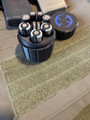 LAPG Tactical Spare Battery Container TDP-RDBATTHOLDER, black cylindrical battery storage container with removable lid, holding multiple batteries.