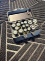 LAPG Battery Storage Box TDP-SQBATTHOLDER, contains various batteries in a black plastic organizer case placed on a textured outdoor surface.