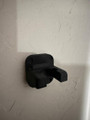 LAPG AR-15 Buffer Tube Wall Mount, black wall mount bracket for rifle buffer tubes attached to a wall, model TDP-ARWM.