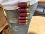LAPG Shotgun Shell Holder - 3 Pack, red and brass shotgun shell holder attached to a person's belt.