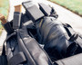 OTB Boots Fusion 6 Black Tactical Boot, black hiking boots with durable construction and ankle support, placed on a tactical backpack outdoors.