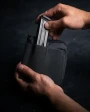 Eberlestock Fade Tactical Admin Pouch FA4MB, black tactical admin pouch with a magazine being placed inside.