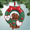 Christmas Ornament of Brown Dog Hanging from Wreath