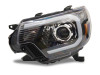 Raxiom 12-15 Toyota Tacoma Axial Projector Headlights w/ SEQL LED Bar- Blk Housing (Clear Lens) - TT21850