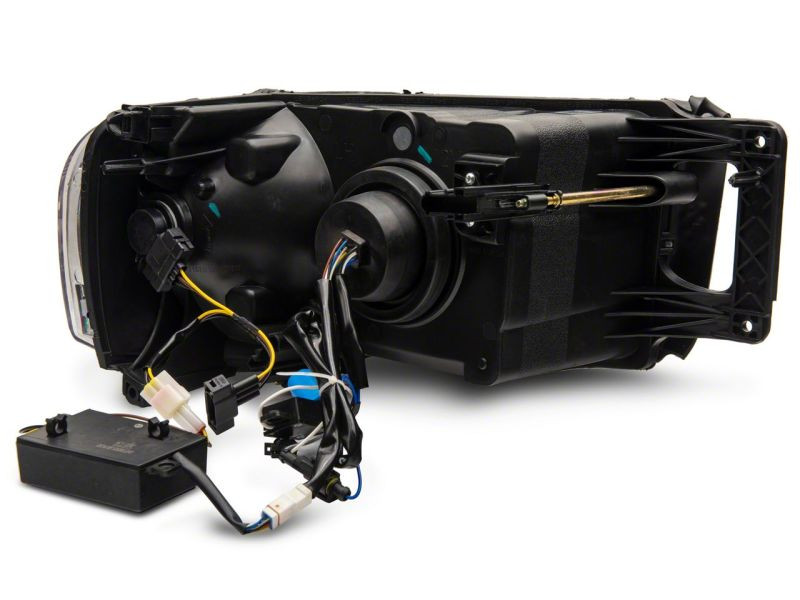 Raxiom 02-05 Dodge RAM 1500 LED Projector Headlights w/ SEQL LED Bar- Blk Housing (Clear Lens) - R131478