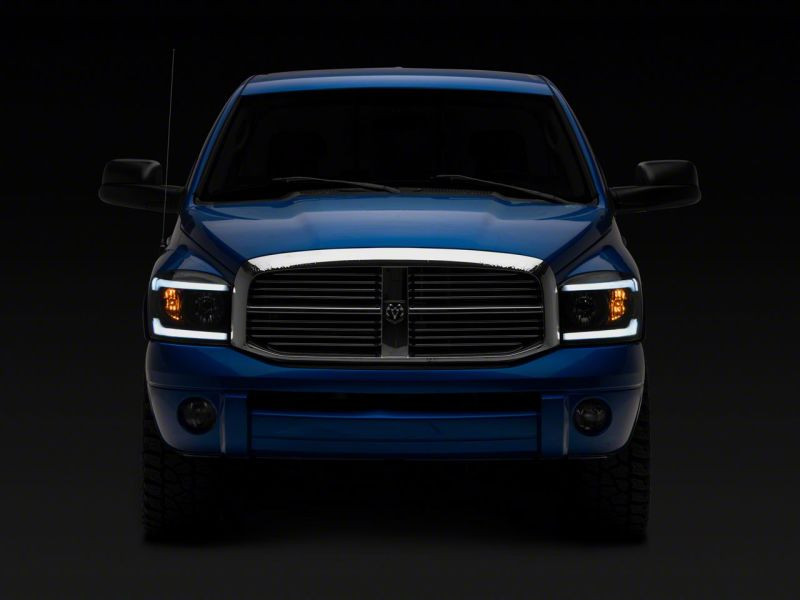 Raxiom 06-09 Dodge RAM 1500/2500/3500 Axial Headlights w/ SEQL LED Bar- Blk Housing (Clear Lens) - R131480