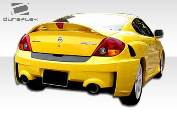 2003-2006 Hyundai Tiburon Duraflex SC-5 Rear Bumper Cover - 1 Piece / Vehicle Year Make Model Trim - 2003-2006-Hyundai Tiburon ALL / Product Type - Rear Bumper / Style Name -SC-5 / Kit Material - FRP (Fiberglass Reinforced Plastics) / Notes -