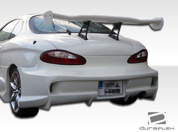 1997-1999 Hyundai Tiburon Duraflex Vader 2 Rear Bumper Cover - 1 Piece (S) / Vehicle Year Make Model Trim - 1997-1999-Hyundai Tiburon ALL / Product Type - Rear Bumper / Style Name -Vader 2 / Kit Material - FRP (Fiberglass Reinforced Plastics) / Notes - Note: All Overstock products are sold on a first come, first serve basis. Overstock products are sold as is, and all sales are final. Overstock products may not be returned or exchanged.