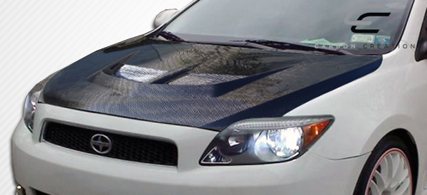 2005-2010 Scion tC Carbon Creations Evo Hood - 1 Piece / Vehicle Year Make Model Trim - 2005-2010-Scion TC ALL / Product Type - Hood / Style Name -Evo / Kit Material - Carbon Fiber / Notes - Note: Hood pins are required.