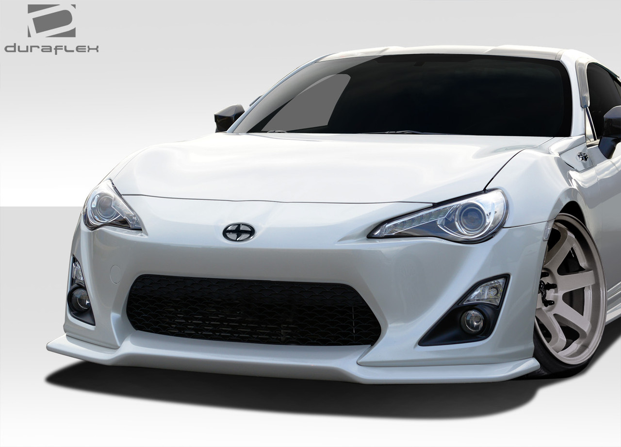 2013-2016 Scion FR-S Duraflex V-Speed Front Lip Spoiler - 1 Piece / Vehicle Year Make Model Trim - 2013-2016-Scion FRS ALL / Product Type - Front Lip/Add On / Style Name -V-Speed / Kit Material - FRP (Fiberglass Reinforced Plastics) / Notes -
