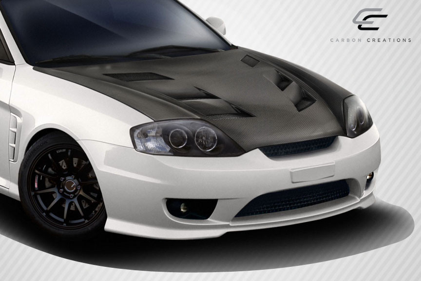2003-2006 Hyundai Tiburon Carbon Creations DriTech AM-S Hood - 1 Piece / Vehicle Year Make Model Trim - 2003-2006-Hyundai Tiburon ALL / Product Type - Hood / Style Name -AM-S / Kit Material - Carbon Fiber / Notes - Note: Hood pins are required.