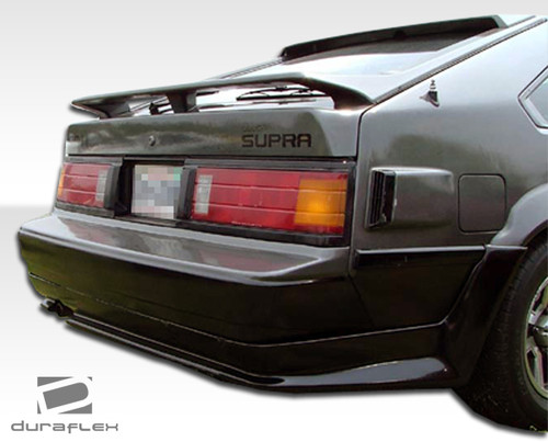 1982-1986 Toyota Supra Duraflex F-1 Rear Lip Under Spoiler Air Dam - 1 Piece / Vehicle Year Make Model Trim - 1982-1986-Toyota Supra ALL / Product Type - Rear Lip/Add On / Style Name -F-1 / Kit Material - FRP (Fiberglass Reinforced Plastics) / Notes -