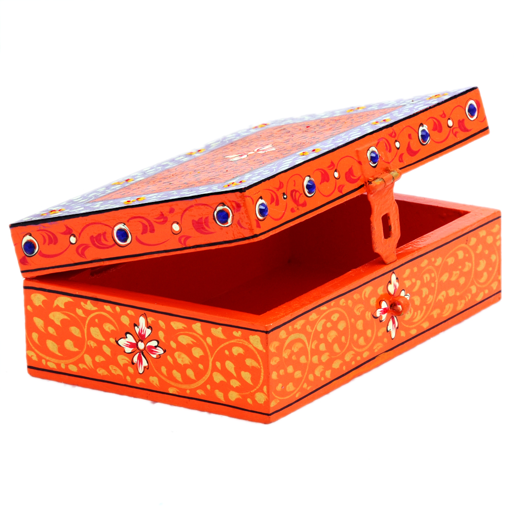 Hand-painted orange and purple keepsake box displayed on a dressing table, artisan jewelry and memory storage box inspired by Rajasthan