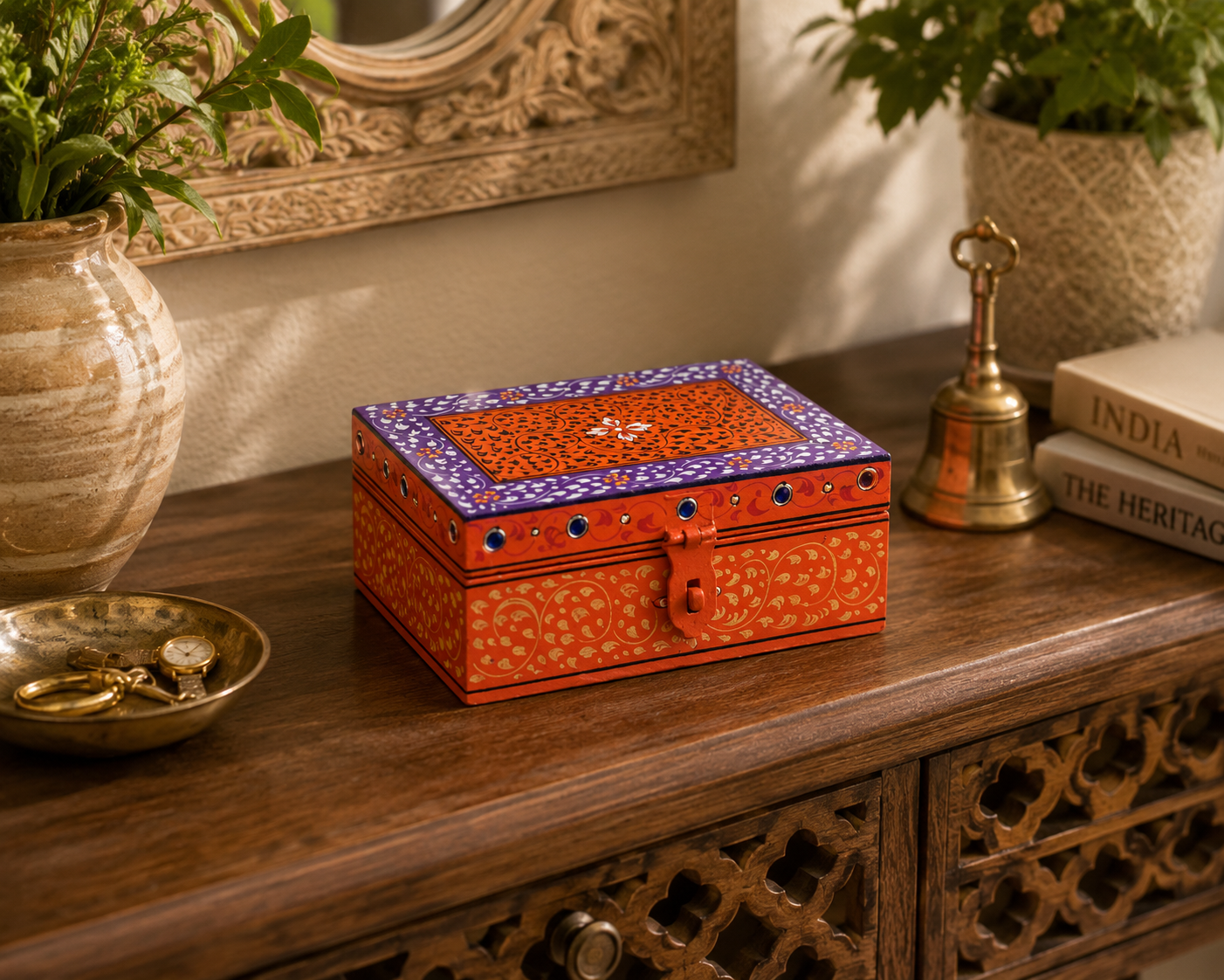 Hand-painted orange and purple keepsake box displayed on a dressing table, artisan jewelry and memory storage box inspired by Rajasthan