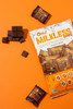 Milkless Minis chocolate bag displayed with individually wrapped chocolates against an orange background.