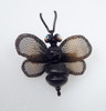 Whimsical Bee Pin shown in black with antique brass wings