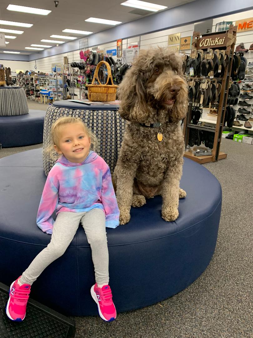 HAnk sitting with another happy customer in her new shoes.