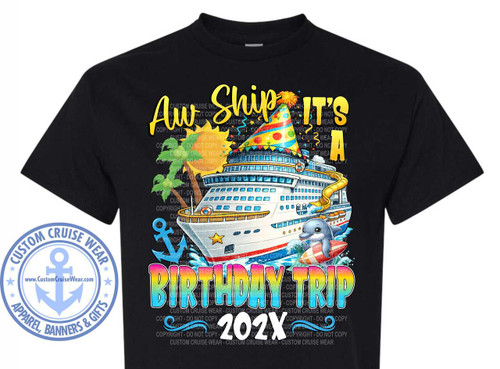 The image showcases a black t-shirt featuring a colorful graphic design centered on the front. The design has a cruise ship theme, and the phrase "Aw Ship It's A BIRTHDAY TRIP 202X" is prominently displayed.

The words "Aw Ship" are written in a large, curved, yellow font at the top. The words "It's A" are above the cruise ship, also in yellow. A cruise ship is the focal point of the image, depicted in white with blue and red accents, adorned with a party hat and a yellow slide on the side. A smiling dolphin is shown riding a surfboard near the ship. The phrase "BIRTHDAY TRIP" is written below the ship in a vibrant, rainbow-colored font. Below that, "202X" is included in white font.
