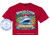 The image displays a close-up of a dark red t-shirt with a colorful graphic design printed on the front. The t-shirt fabric appears to be a soft cotton blend, with visible stitching and texture. The overall design is a vibrant tropical scene depicting a cruise adventure.

The central element of the graphic is a large, white cruise ship with blue accents, sailing on a choppy, turquoise sea. The ship is shown from a slight angle, appearing to be approaching a tropical coastline. The water is depicted with frothy white waves, suggesting movement and spray.

To the right of the ship, a quaint, colorful coastal town is illustrated. The buildings are painted in bright yellows, oranges, and blues, with red-tiled roofs. A historic-looking stone tower or fort with arched windows is prominent, overlooking the harbor. Tropical palm trees with lush green fronds frame the scene from the left and right sides of the graphic. Pink and red hibiscus flowers are scattered amongst the foliage, adding pops of vibrant color.

Above the cruise ship and town, a stylized banner in shades of blue and yellow proclaims "Venezia Cruise Adventure" in a decorative, flowing font. The word "Venezia" is in a larger, lighter blue with a white outline, while "Cruise Adventure" is in a slightly smaller, darker blue with a yellow outline.

Below the ship and town, a textured rope border frames a banner displaying the cruise itinerary. The banner lists several port names in white text, separated by small black dots: "PORT CANAVERAL", "ST. THOMAS", "ANTIGUA", "DOMINICA", "BARBADOS", "GRENADA", "ST. MAARTEN", "ST. KITTS", "SAN JUAN".

At the very bottom of the graphic, a dark blue banner with white text indicates the cruise dates: "NOVEMBER 29 - DECEMBER 13, 2026". A small blue star is placed just above the dates.

On the left side of the t-shirt, a circular emblem is printed. This emblem features a light blue anchor within a circle, surrounded by a darker blue border. Text in the border reads "CUSTOM CRUISE WEAR" at the top and "APPAREL, BANNERS & GIFTS" at the bottom, with small blue stars separating these phrases. A website address, "www.CustomCruiseWear.com", is visible inside the central anchor circle.

The color palette of the graphic is rich and tropical, dominated by blues of the ocean and sky, vibrant greens of the foliage, and the bright, warm colors of the buildings and flowers. The cruise ship is primarily white and blue, standing out against the colorful background. The text elements are generally in white, yellow, and blue, ensuring readability.

The composition is balanced, with the cruise ship as the main focal point, supported by the surrounding tropical elements. The arrangement guides the viewer's eye from the title at the top, down through the scene to the itinerary and dates at the bottom. The circular emblem on the left serves as a secondary branding element.

Subtle details include the white spray of the waves, the texture of the rope border, and the small dots separating the port names. Watermarks appear to be present throughout the graphic, indicating copyright. At the bottom of the t-shirt, outside the main graphic, text in white reads "SHOWN ON GILDAN ANTIQUE CHERRY", indicating the specific t-shirt color and brand.