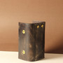 Back view of handmade dark brown full-grain leather key holder with brass snap closures