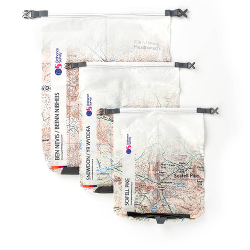 The 3 empty bags of the OS 3 Peaks Dry Bags lie on top of each other from smallest to largest showing the map name and OS logo along the right side of the bags