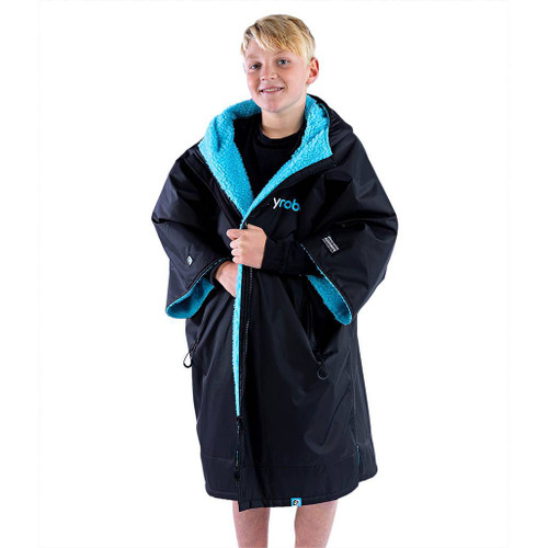 Child standing wearing the Dryrobe Advance Kids Black Short Sleeve Outdoor Robe facing front
