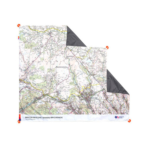 The OS Brecon Beacons Picnic Blanket by Ordnance Survey Outdoor Kit front view of the blanket with the corner turned down to show the waterproof back