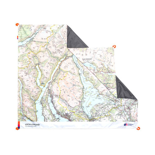 The OS Loch Lomond Picnic Blanket by Ordnance Survey Outdoor Kit front view of the blanket with the corner turned down to show the waterproof back