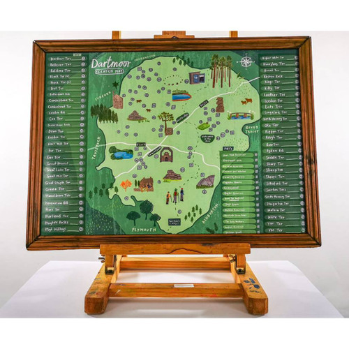 Full view of a framed map of the Dartmoor Scratch Off Map on an easel