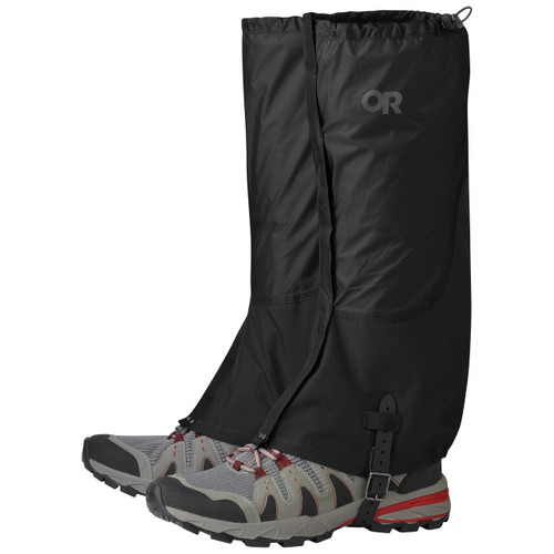 Outdoor Research Women's Helium Gaiters in black with OR logo buckled under walking shoes and hooked to boot laces