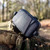 Back view of the OS GPS small case by Ordnance Survey Outdoor Kit sat on a tree stump in open woodland