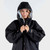 Person standing wearing the Dryrobe Advance Adults Grey Short Sleeve Outdoor Robe facing front close up with the hood up