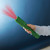 Darkened image with a child's hand holding the torch with an illustration of red light emitted from the Brainstorm Toys Outdoor Adventure Night Vision Torch